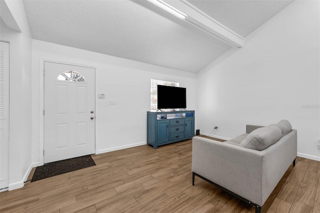 4066 Vanet Ct, Orlando, FL 32822 - living room with vaulted ceiling with beams, light wood-type flooring, baseboards, and a textured ceiling
