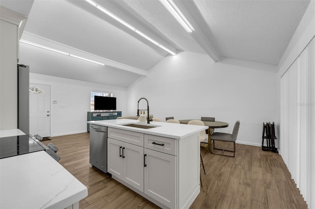 4066 Vanet Ct, Orlando, FL 32822 - kitchen featuring white cabinets, dishwasher, a sink, light wood-style floors, and vaulted ceiling with beams