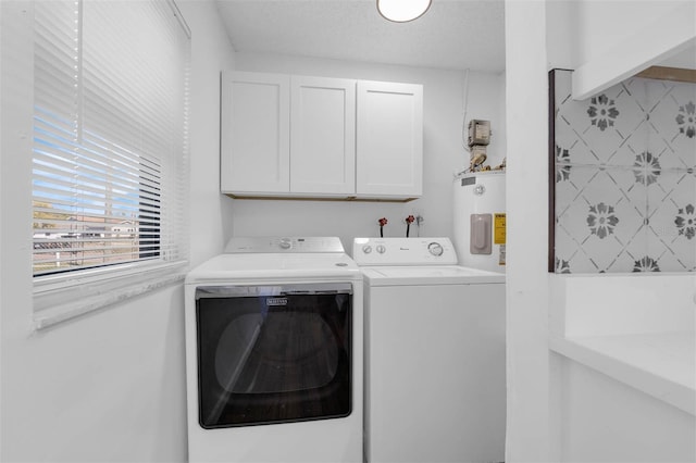 4066 Vanet Ct, Orlando, FL 32822 - laundry room featuring washing machine and clothes dryer, cabinet space, a textured ceiling, and electric water heater