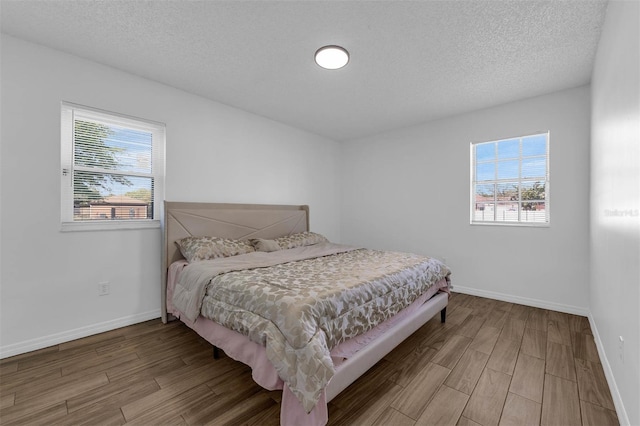 4066 Vanet Ct, Orlando, FL 32822 - bedroom featuring baseboards, multiple windows, and wood finished floors