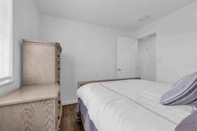 4066 Vanet Ct, Orlando, FL 32822 - bedroom featuring dark wood-style floors and visible vents
