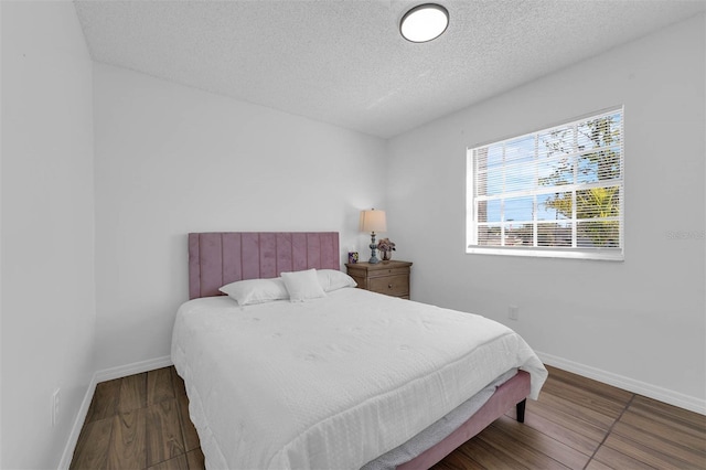 4066 Vanet Ct, Orlando, FL 32822 - bedroom with baseboards, wood finished floors, and a textured ceiling