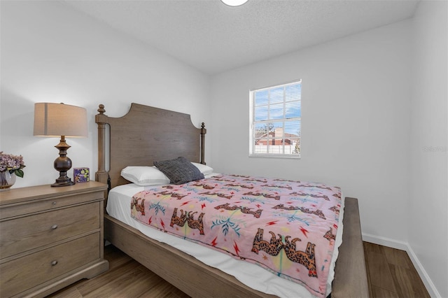4066 Vanet Ct, Orlando, FL 32822 - bedroom featuring baseboards, wood finished floors, and a textured ceiling