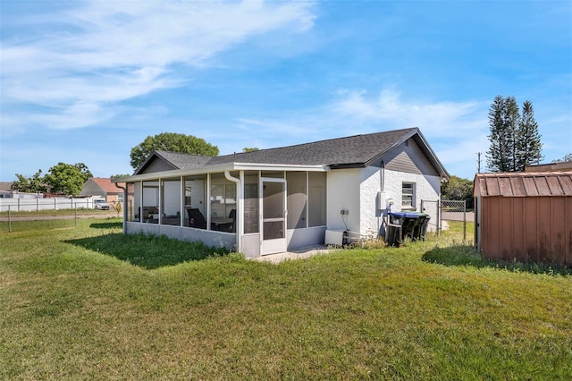 4066 Vanet Ct, Orlando, FL 32822 - back of house featuring an outbuilding, a sunroom, fence, a storage unit, and a lawn
