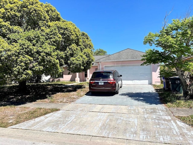 view of front of home featuring driveway, stucco siding, and an attached garage