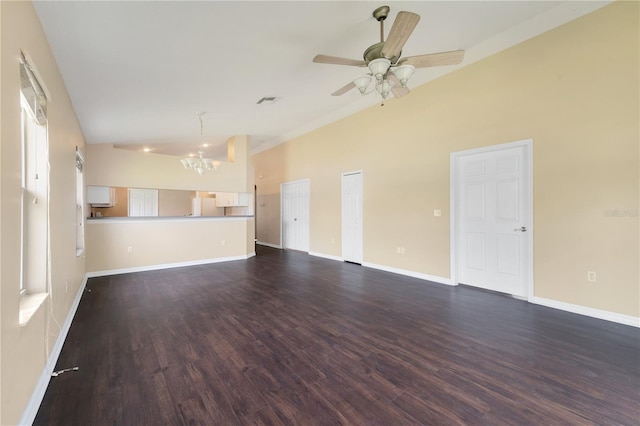 unfurnished living room featuring dark wood finished floors, baseboards, lofted ceiling, and ceiling fan with notable chandelier