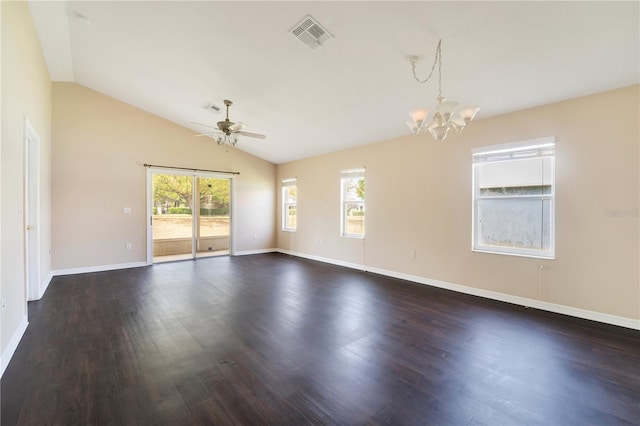 spare room featuring ceiling fan with notable chandelier, visible vents, dark wood-type flooring, and vaulted ceiling