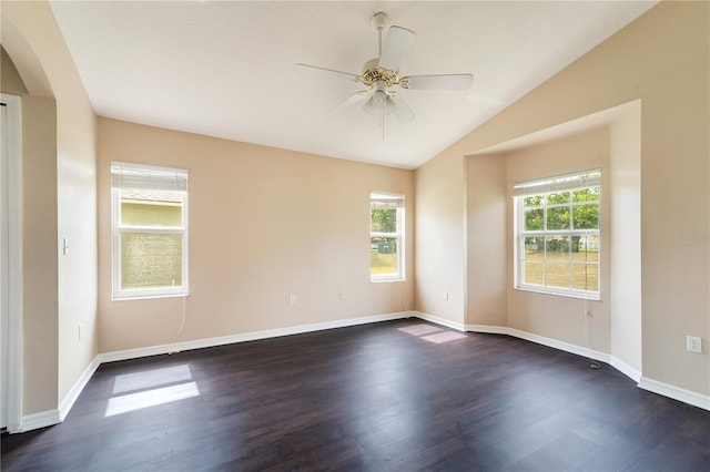 empty room with plenty of natural light, arched walkways, lofted ceiling, and dark wood finished floors