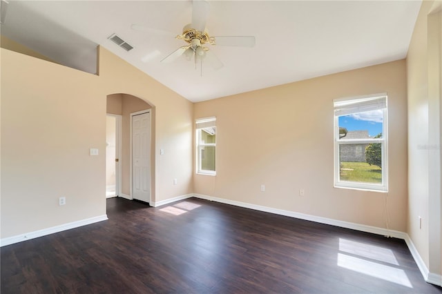 unfurnished room featuring a ceiling fan, dark wood-style flooring, arched walkways, and visible vents