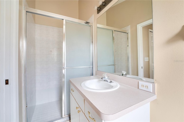 full bath with vanity and a stall shower