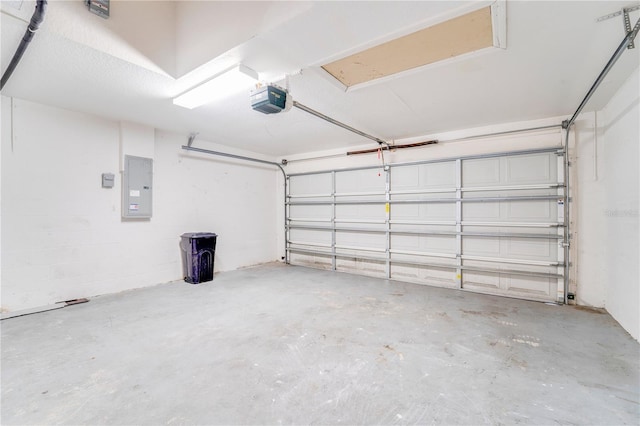 garage featuring a garage door opener and electric panel