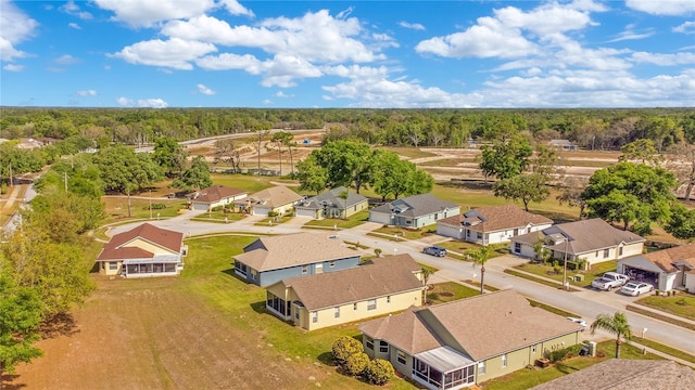birds eye view of property with a view of trees and a residential view