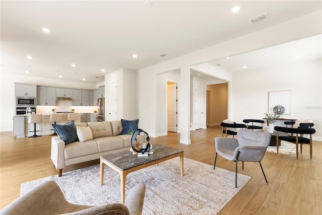 13231 Panama Beach Ct, Orlando, FL 32827 - living room featuring light wood-style flooring, baseboards, and recessed lighting