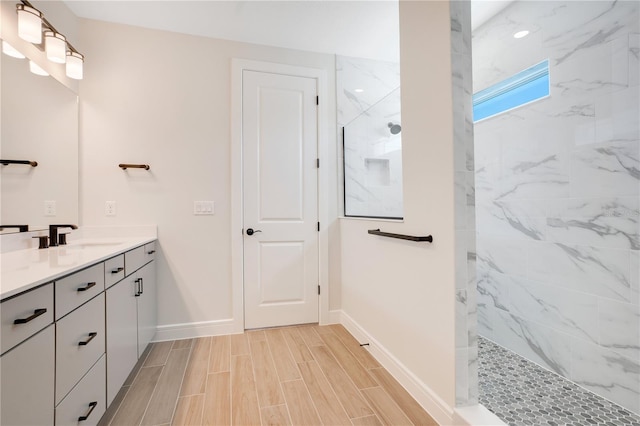 13231 Panama Beach Ct, Orlando, FL 32827 - bathroom with vanity, a marble finish shower, baseboards, and wood tiled floors