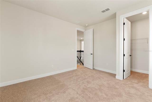 13231 Panama Beach Ct, Orlando, FL 32827 - unfurnished bedroom featuring light colored carpet, baseboards, recessed lighting, and a walk in closet