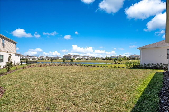 13231 Panama Beach Ct, Orlando, FL 32827 - view of green lawn featuring a residential view and a water view