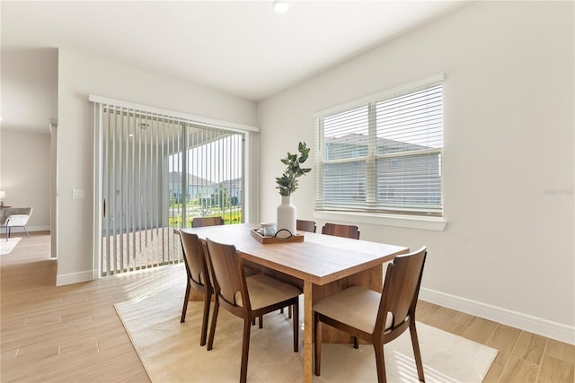 13231 Panama Beach Ct, Orlando, FL 32827 - dining room with plenty of natural light, baseboards, and light wood finished floors