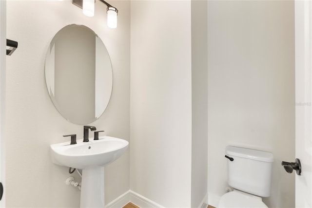13231 Panama Beach Ct, Orlando, FL 32827 - half bathroom featuring toilet and baseboards