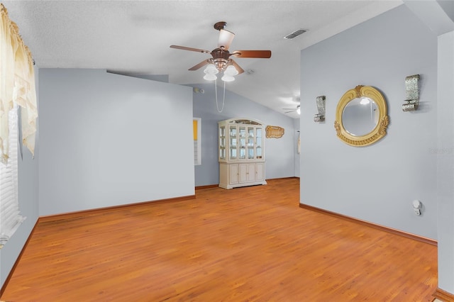 103 Nassau Pl, Kissimmee, FL 34758 - unfurnished bedroom featuring baseboards, visible vents, wood finished floors, and vaulted ceiling