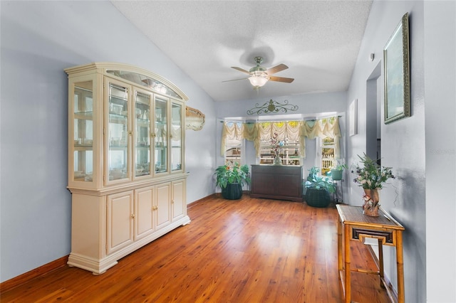 103 Nassau Pl, Kissimmee, FL 34758 - hall featuring a textured ceiling, baseboards, and wood finished floors