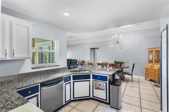 103 Nassau Pl, Kissimmee, FL 34758 - kitchen with a peninsula, dishwasher, white cabinetry, a sink, and a notable chandelier