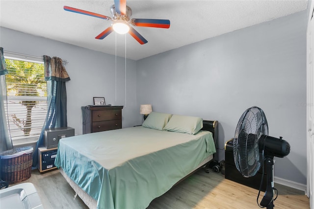 103 Nassau Pl, Kissimmee, FL 34758 - bedroom featuring a ceiling fan, a textured ceiling, baseboards, and wood finished floors