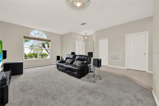tiled cinema room with baseboards, carpet flooring, and visible vents
