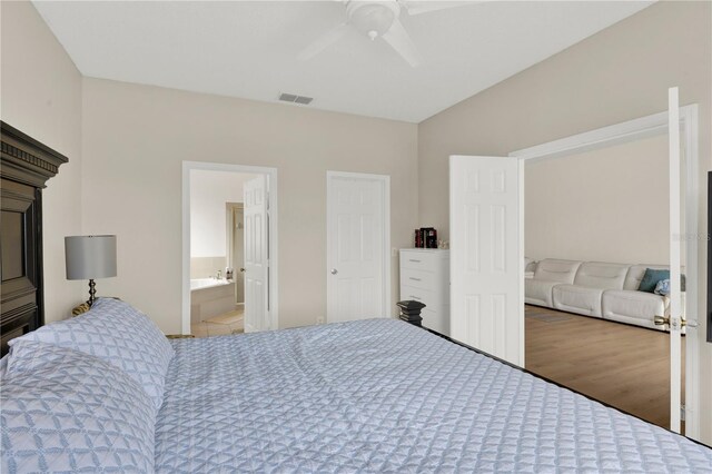 bedroom featuring ceiling fan, visible vents, and wood finished floors