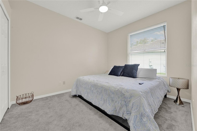 carpeted bedroom with baseboards, ceiling fan, and visible vents