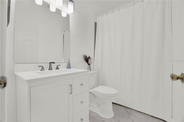 bathroom featuring marble finish floor, toilet, and vanity