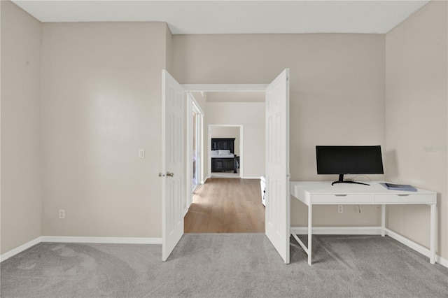 unfurnished office featuring carpet and baseboards