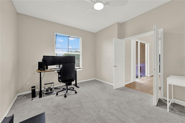 office space featuring baseboards, carpet floors, and a ceiling fan