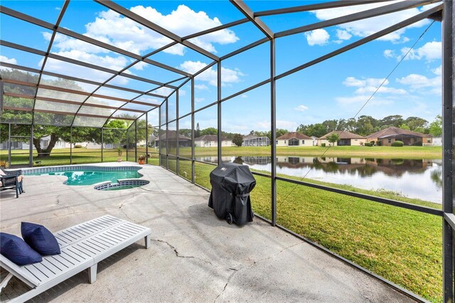 view of pool with a water view, a lanai, a yard, and a patio area