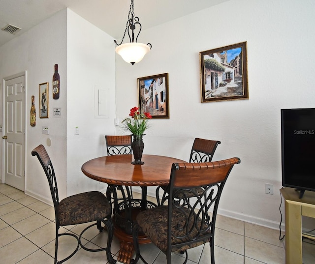 dining room featuring light tile patterned flooring, baseboards, and visible vents