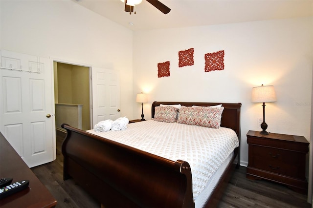 bedroom featuring dark wood-type flooring, lofted ceiling, baseboards, and a ceiling fan