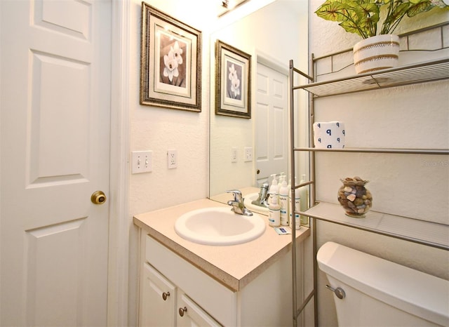 bathroom with toilet and vanity