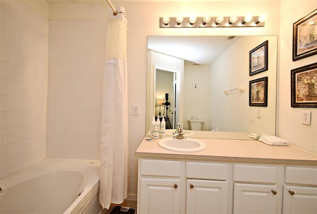 bathroom featuring shower / bath combo and vanity