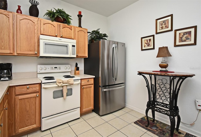 kitchen with white appliances, light countertops, and light tile patterned floors