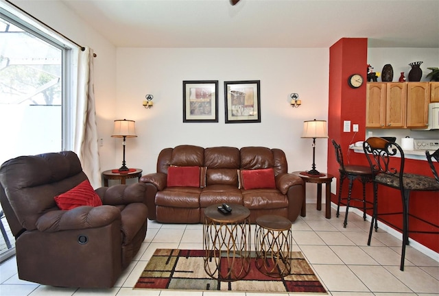 living room featuring light tile patterned floors and baseboards