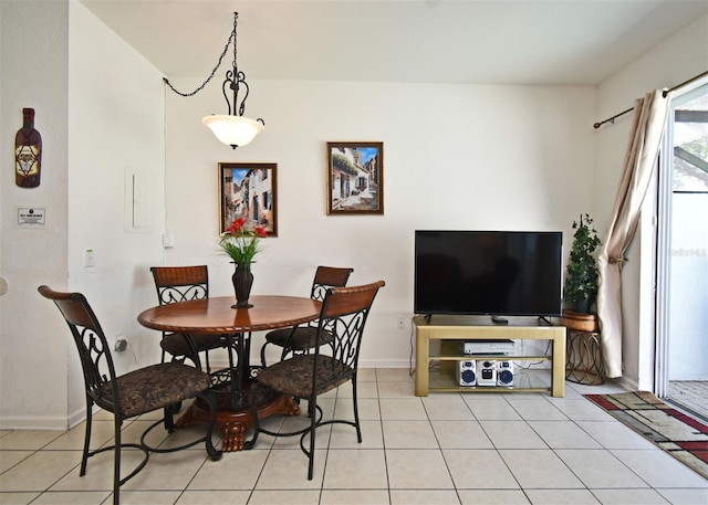 dining space with baseboards and light tile patterned floors