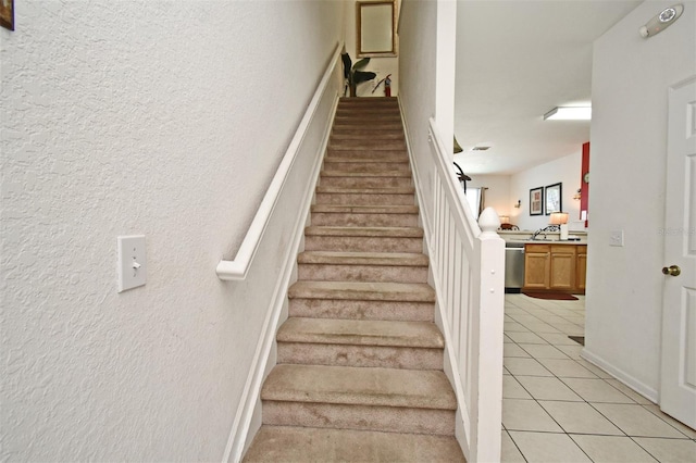 stairway with tile patterned floors