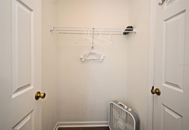 laundry area with baseboards