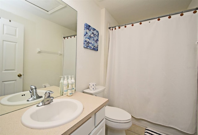 bathroom featuring tile patterned floors, toilet, and vanity