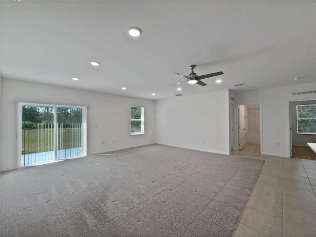 unfurnished room with visible vents, baseboards, recessed lighting, a ceiling fan, and light carpet