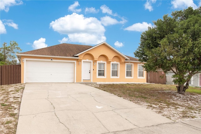 ranch-style house featuring concrete driveway, stucco siding, fence, a shingled roof, and a garage