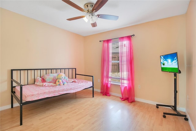 bedroom with baseboards, wood finished floors, and ceiling fan