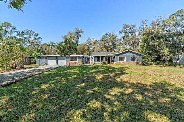 single story home featuring an attached garage, driveway, and a front yard