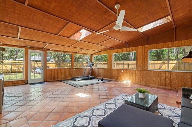unfurnished sunroom featuring a skylight