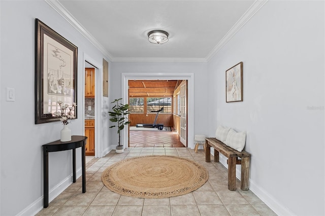 hallway with baseboards, ornamental molding, and light tile patterned floors