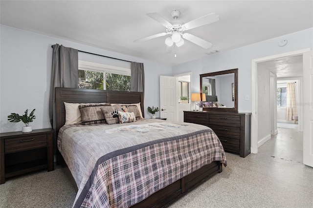bedroom featuring baseboards, visible vents, and ceiling fan